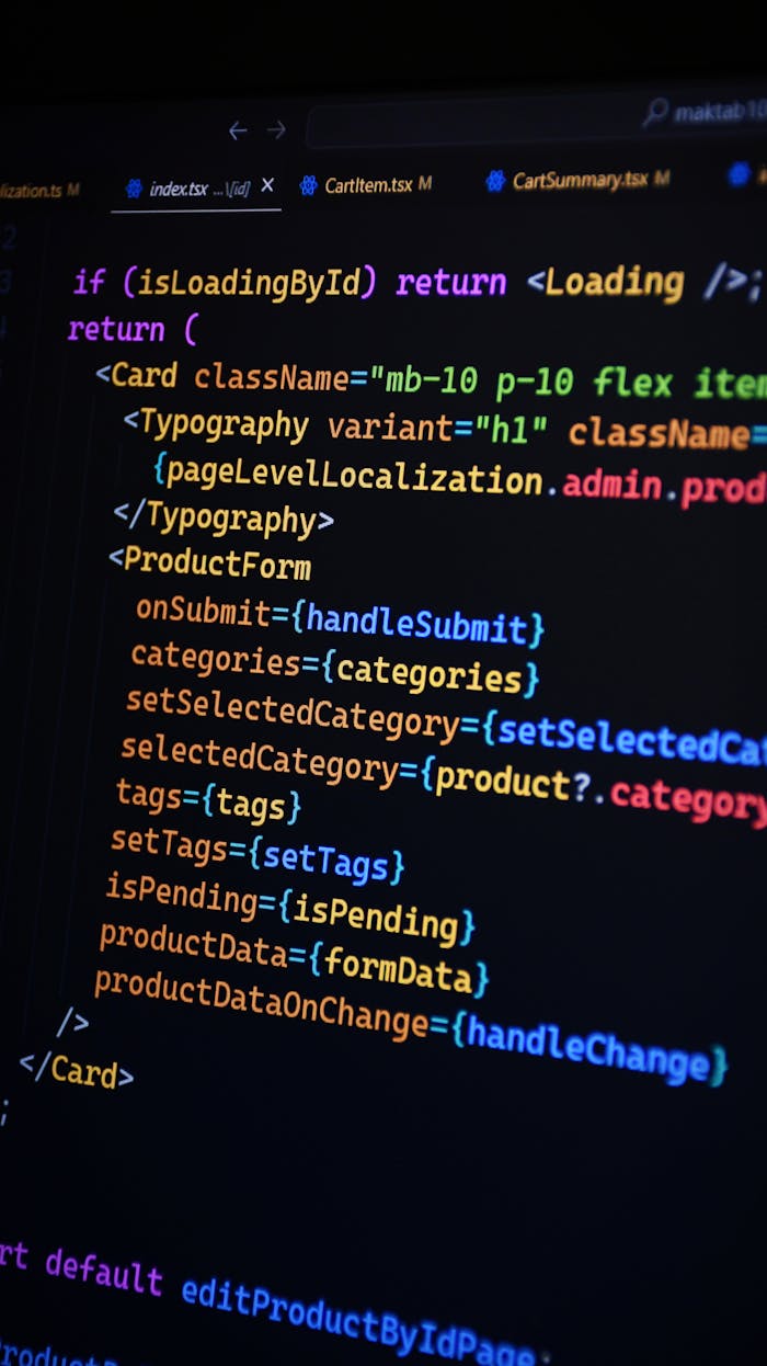 Close-up of JSX code on a monitor, showcasing colorful syntax used in ReactJS development.